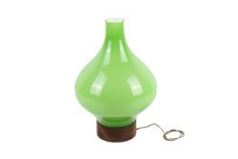 A 20th century green glass lamp. Of bulbous baluster form, mounted on a circular wooden base, H37.