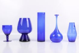Five pieces of blue glassware.