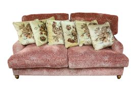 An unbranded contemporary red upholstered three seater sofa.