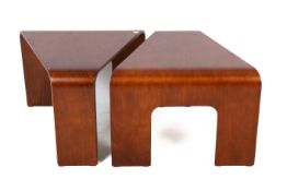 A pair of Ekornes stressless bentwood corner tables. Raised on three supports.