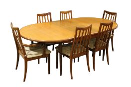 Mid-century G-Plan D end extending teak dining table and six chairs.