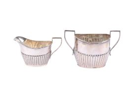 A 20th century silver cream jug and sugar bowl. The jug, maker William Aitken, Birmingham 1908, 54.