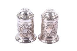 A pair of Victorian silver cylindrical pepperettes.