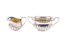 An Edwardian silver sugar bowl and milk jug.