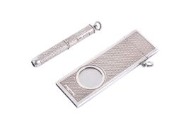 A 20th century silver cigar cutter and cigar piercer.