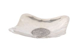 A silver Aztec style calendar dish.