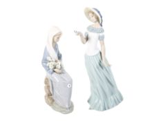 Two Spanish porcelain figures modelled as young women.