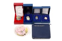 A Moorcroft ceramic plate and four boxed Halcyon Days enamel boxes.