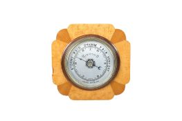 Mid-century aneroid barometer with maple veneer frame.