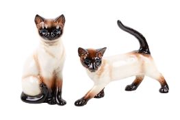 A pair of Goebel West Germany ceramic figures modelled as Siamese cats.