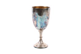 A silver presentation cup. The body undecorated, gilt to the inside, raised on a spread foot.
