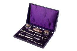 A silver and steel manicure set.