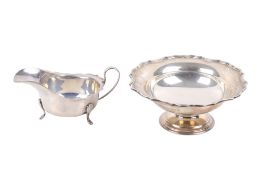 A silver footed dish and a sauceboat.