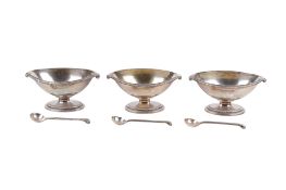 Three Victorian silver salt dishes with spoons.