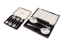 Two sets of silver spoons.