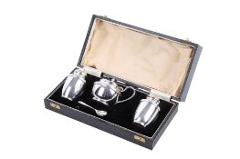 A boxed silver condiment set.