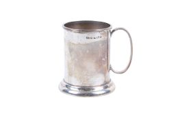 A silver christening mug. The straight body undecorated, over a stepped base.