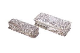 Two slender silver boxes.