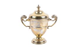 A small gilt silver lidded trophy.