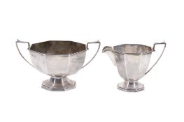 A matching Walker & Hall silver jug and sugar bowl.