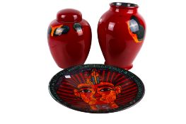 A Poole Pottery charger and two vases.