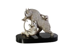 A metal model of a rhinoceros fighting two tigers.