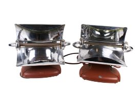 A pair of 1930s Bruton chrome HMV electric bar heaters. Model FRDL 2, on rust red finish base, H38.