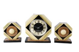An Art Deco onyx and hard stone three piece mantel clock garniture.