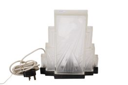 An Art Deco table light with a later glass shade.