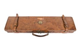 Vintage leather shotgun case with other shooting accessories. Including ear protectors, a bag, etc.