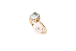 An 18ct gold (tested) and aquamarine ring. Set with one square emerald cut aquamarine of 1.