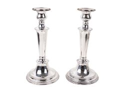 A pair of weighted silver candlesticks.