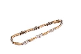 A 14ct gold (tested) bi-colour panel bracelet. Set with round brilliant cut diamonds of 2.