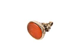 A 9ct gold and carnelian seal fob. The seal intaglio of a seated figure, in a scroll setting, H2.