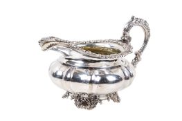 A George IV silver milk jug by Paul Storr Shaped-round or melon-fluted and engraved with a