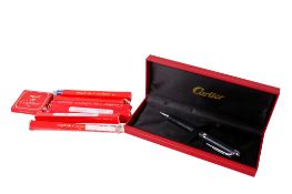 A Cartier ballpoint pen and refills.
