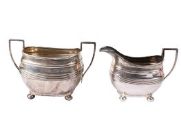 An Edwardian silver sugar pot and cream jug.