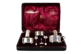 An early 20th century cased silver condiment set.