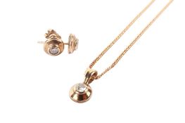 A 9ct gold diamond necklace and earring set. The small diamonds circa 2.