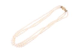 A graduated three strand pearl necklace.