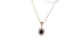 A 9ct gold (tested) blue and white stone pendant.