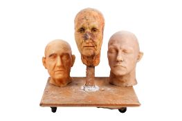 Christopher Tucker (1941-2022). Three wax heads. One mounted on a board with realistic eyes.