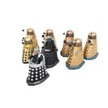 Eight vintage Doctor Who 5" 'Bump and Go' Dalek models. Circa. 1970s, of various colours.