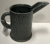 A Walter Keeler mottled blue glazed pottery jug with medallion decoration to base of handle,
