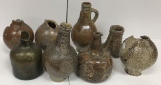 A 17th Century German tiger glazed Bellamine jug with impressed mask and wheel decoration 23 cm