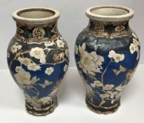 A pair of Japanese Meiji Period Satsuma ware vases decorated with blossom on a blue ground with