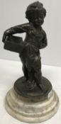 A 19th Century French bronze figure of a street vendor with empty basket on a grey veined white