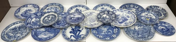 A collection of various blue and white transfer decorated plates including a J & W Ridgeway rural