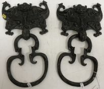 A pair of 19th Century Chinese bronze door knockers as a grotesque mask flanked by two winged five