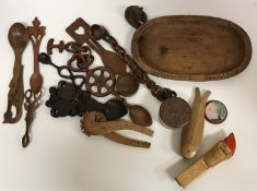 A box of various treen ware to include five various Welsh loving spoons, three pairs of nutcrackers,